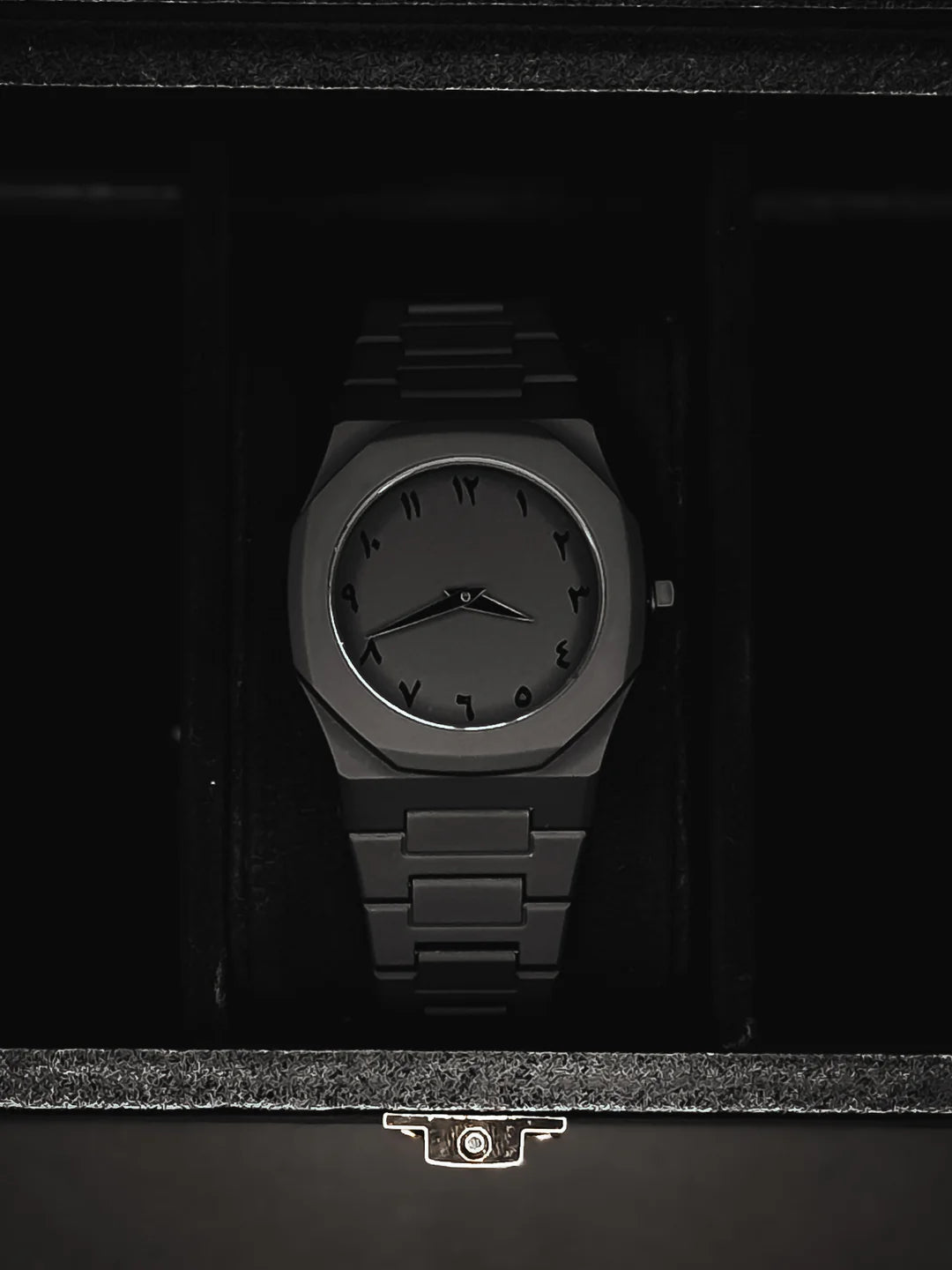 Black wristwatch in a dark box